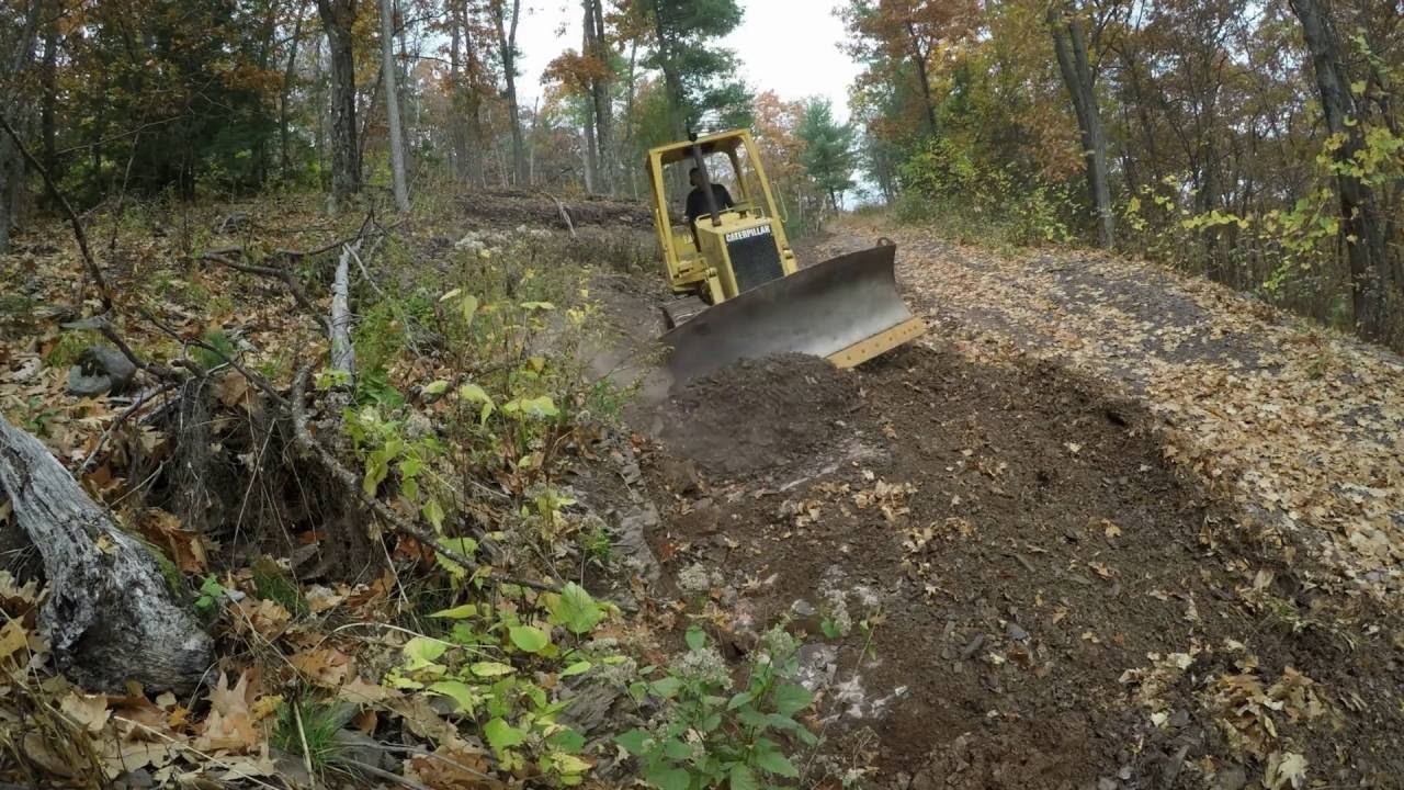 Bulldozer grading driveway hill