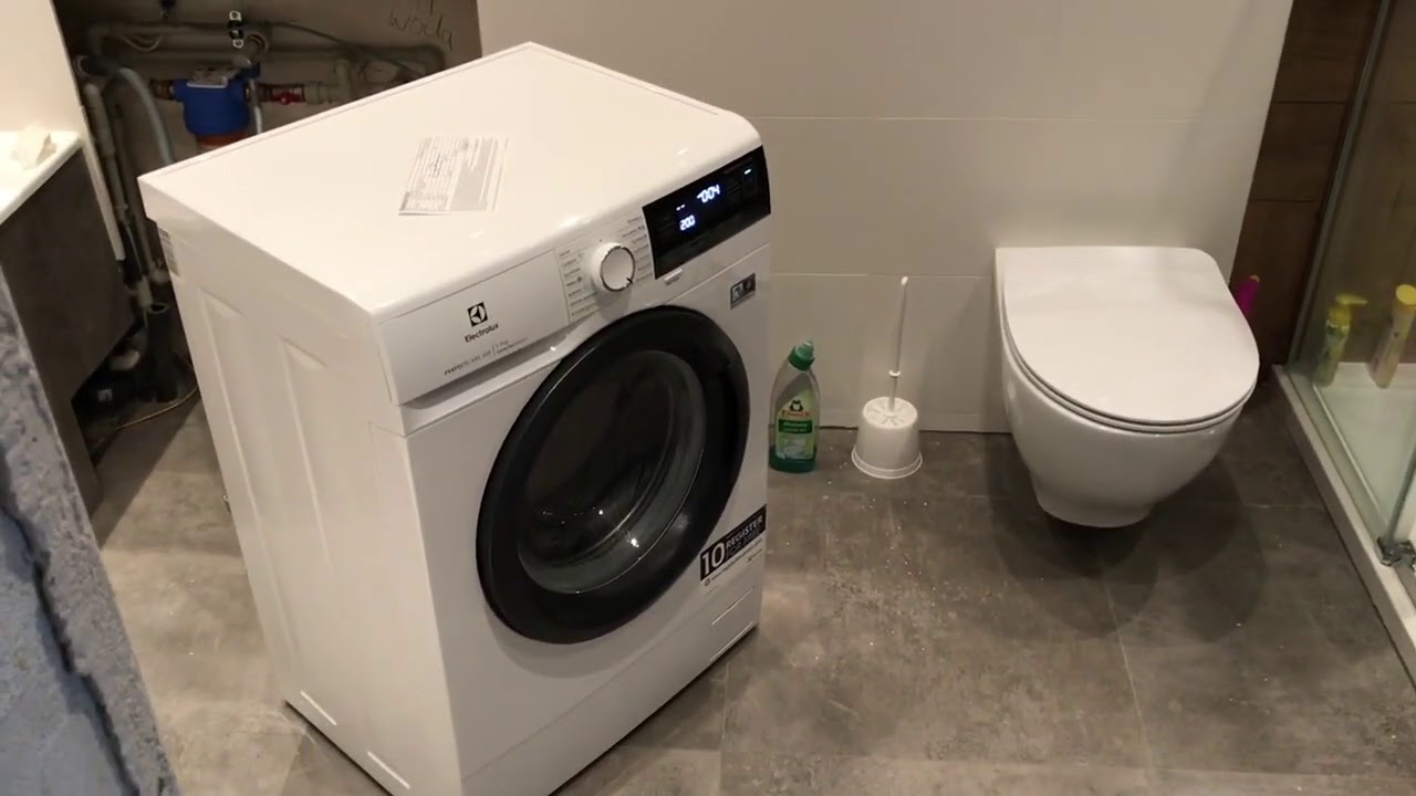 Pralka EW6S327SPI Electrolux ustawiona na środku mojej łazienki na ukos, przez technika serwisu