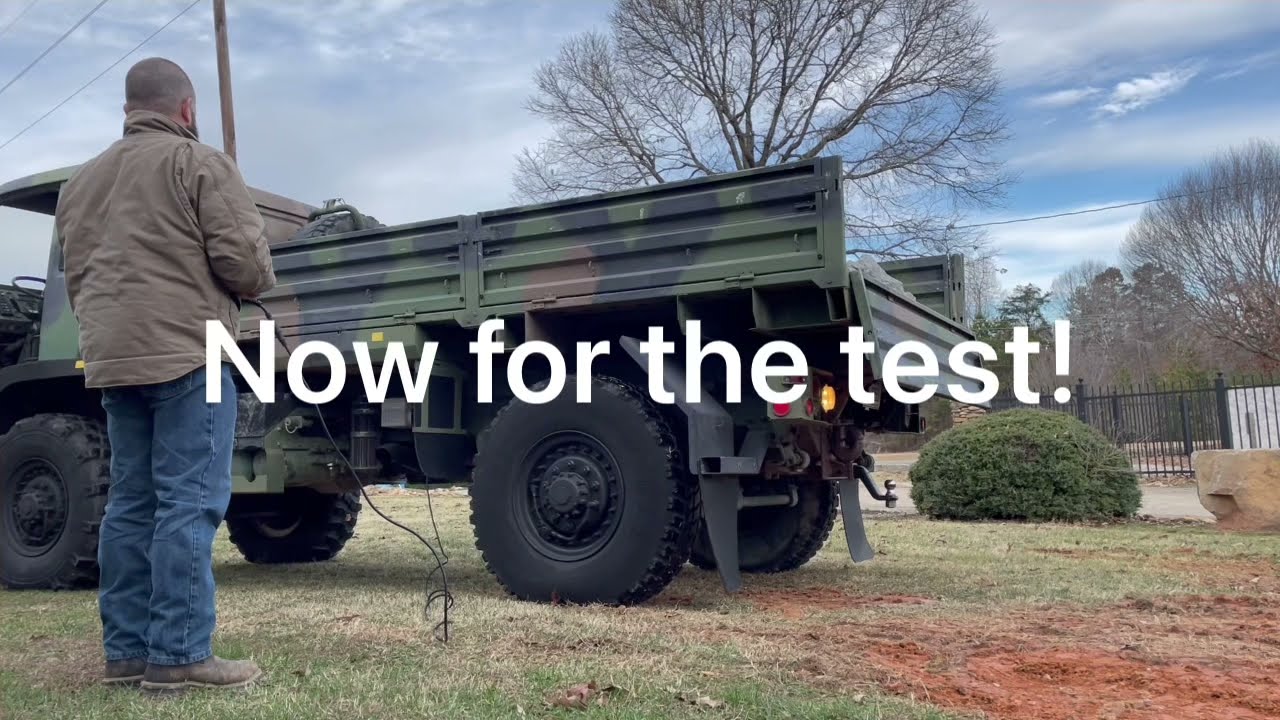 M1078 LMTV dump truck (Moses) dumping 3 yards of Rip Rap