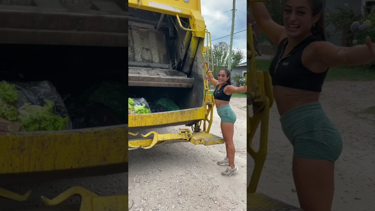 strong girl collecting her own trash throwing it into the garbage truck and compacting it