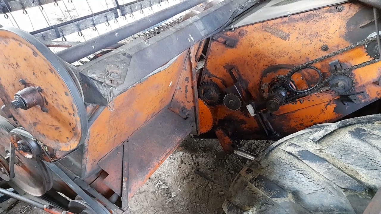 Attaching header to Gleaner combine.
