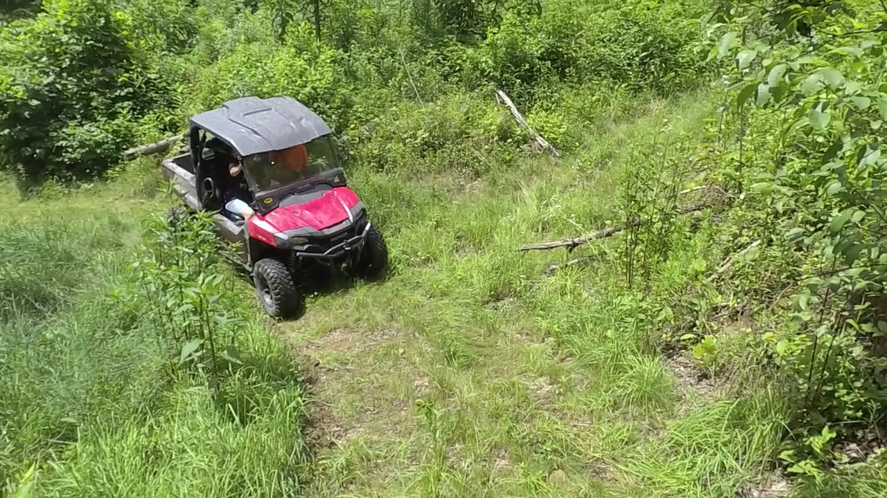 Pioneer 700 and Mudd Man's new Wolverine climb steep hill.