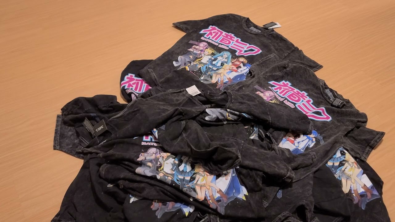 Throwing a bunch of Hatsune Miku group tour shirts on the floor
