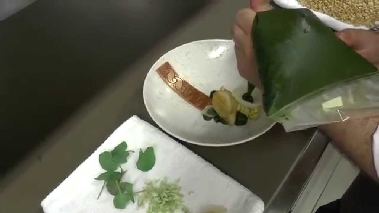 Kris De Roy prepares a sea bass dish at Hofke Van Bazel in Belgium