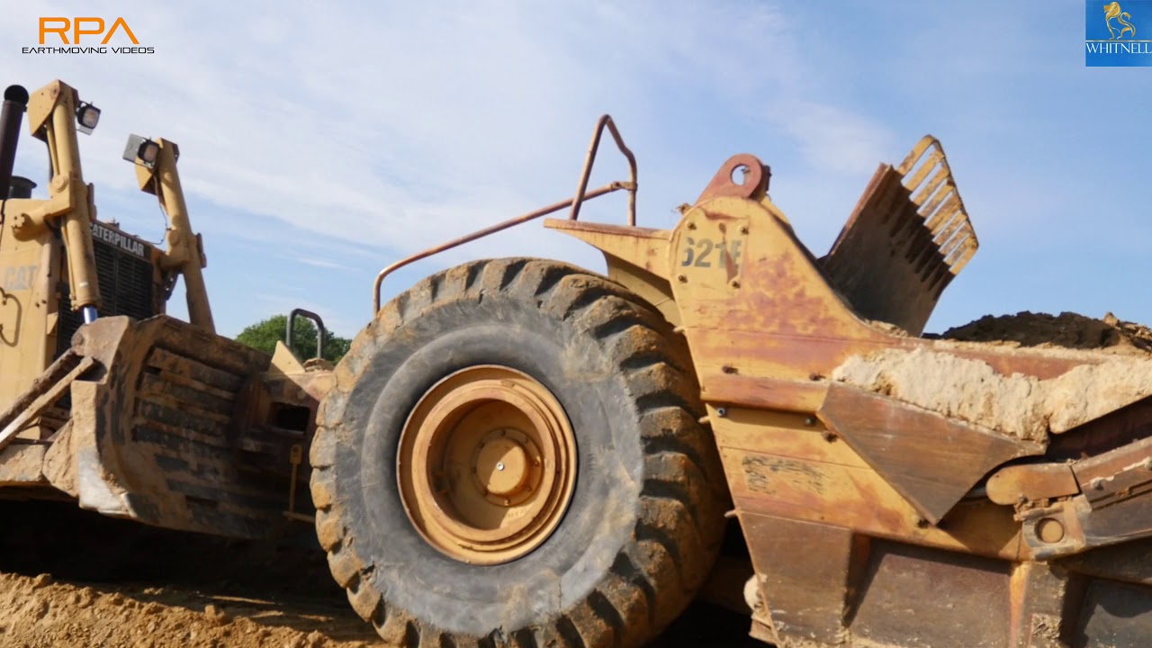 Caterpillar 621E scrapers and a Caterpillar D8N moving overburden in the UK.