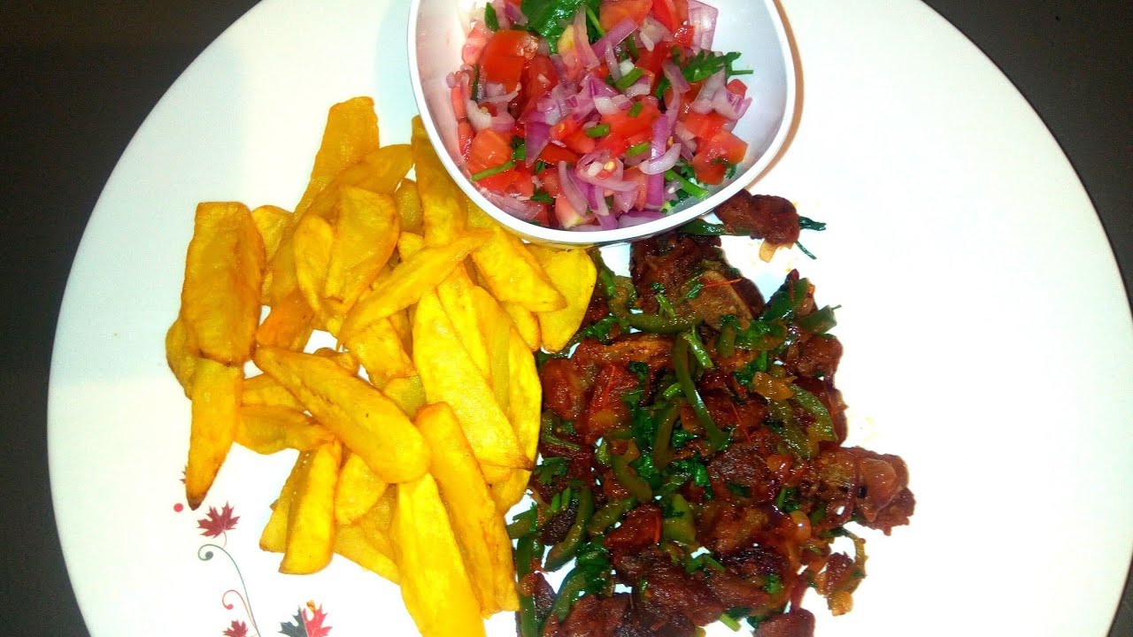 Fried Pork. Served with chips (fried potatoes) and Kachumbari (salad)