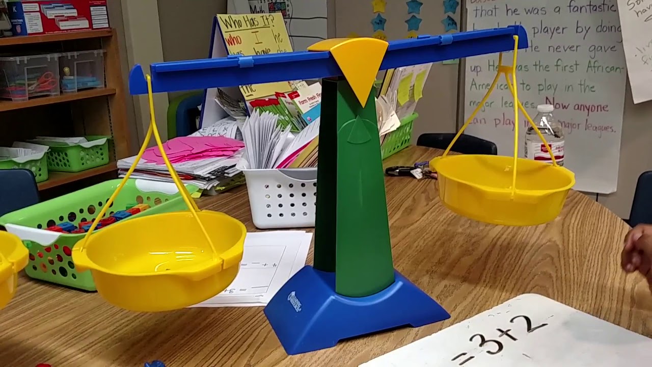 Kindergarten Student Balancing Equations with Scale