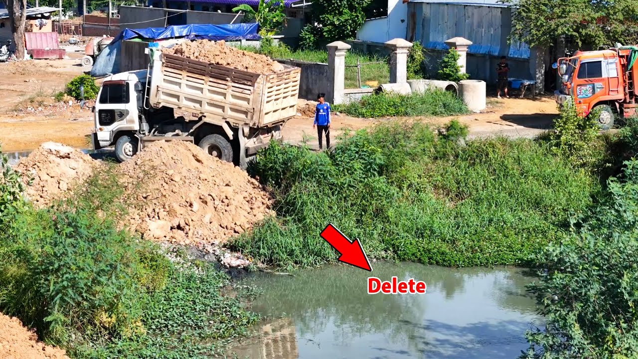 Great project bulldozer and dump pushing soil filling land in action