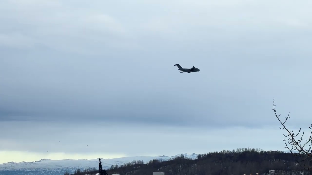 Mt McKinley (f/k/a Denali) Looms Below as US Air Force C-17 Massive Cargo Jet Soars Overhead at Dusk