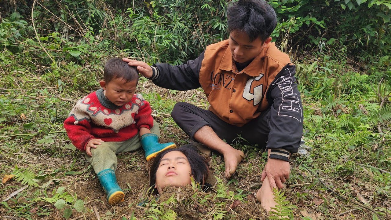 The boy was very sad because his mother had passed away and he and his father had buried her.