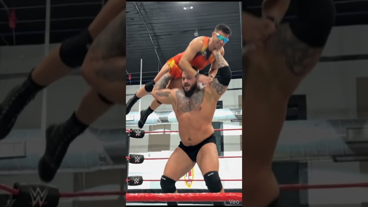 Wrestler Holds Person Overhead performing Gorilla press slam