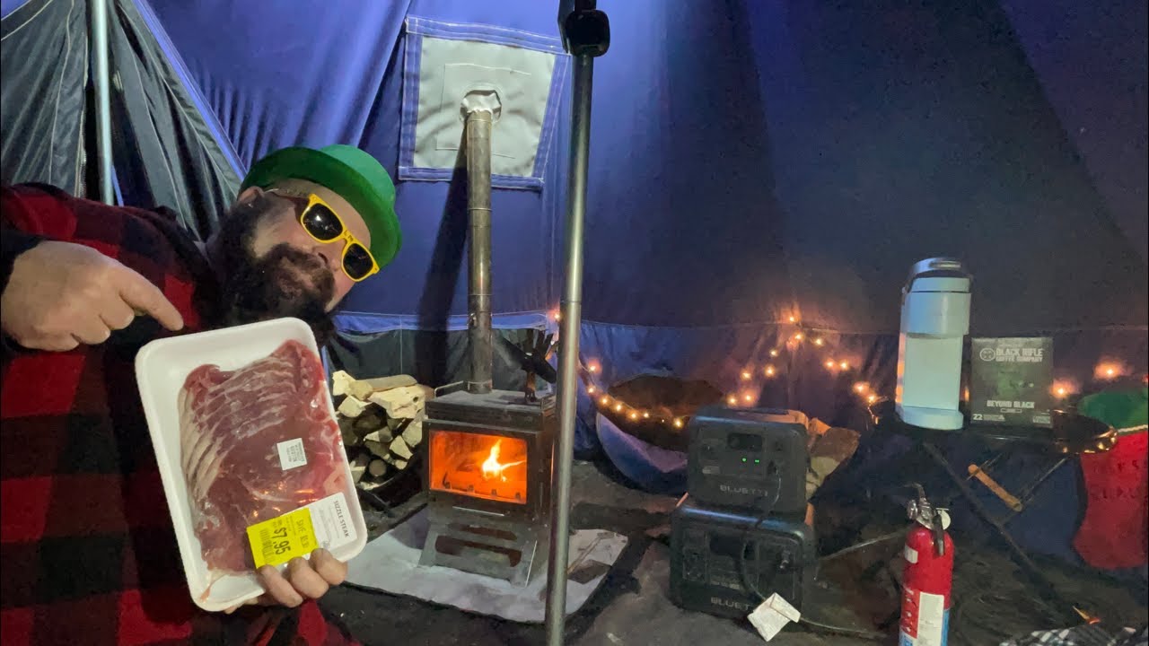 Hot tent, camping sizzle steaks over a beautiful stove