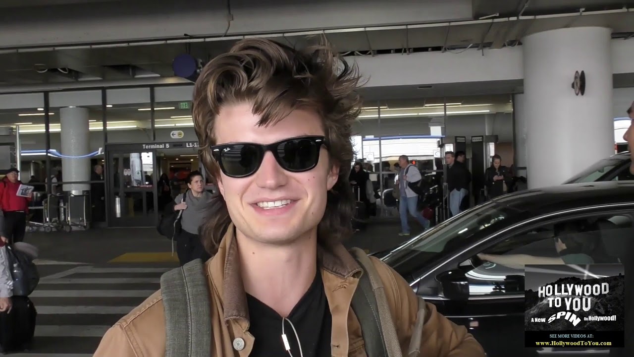 Joe Keery talks about his new hair style for season 2 of Stranger Things while arriving at LAX Airpo