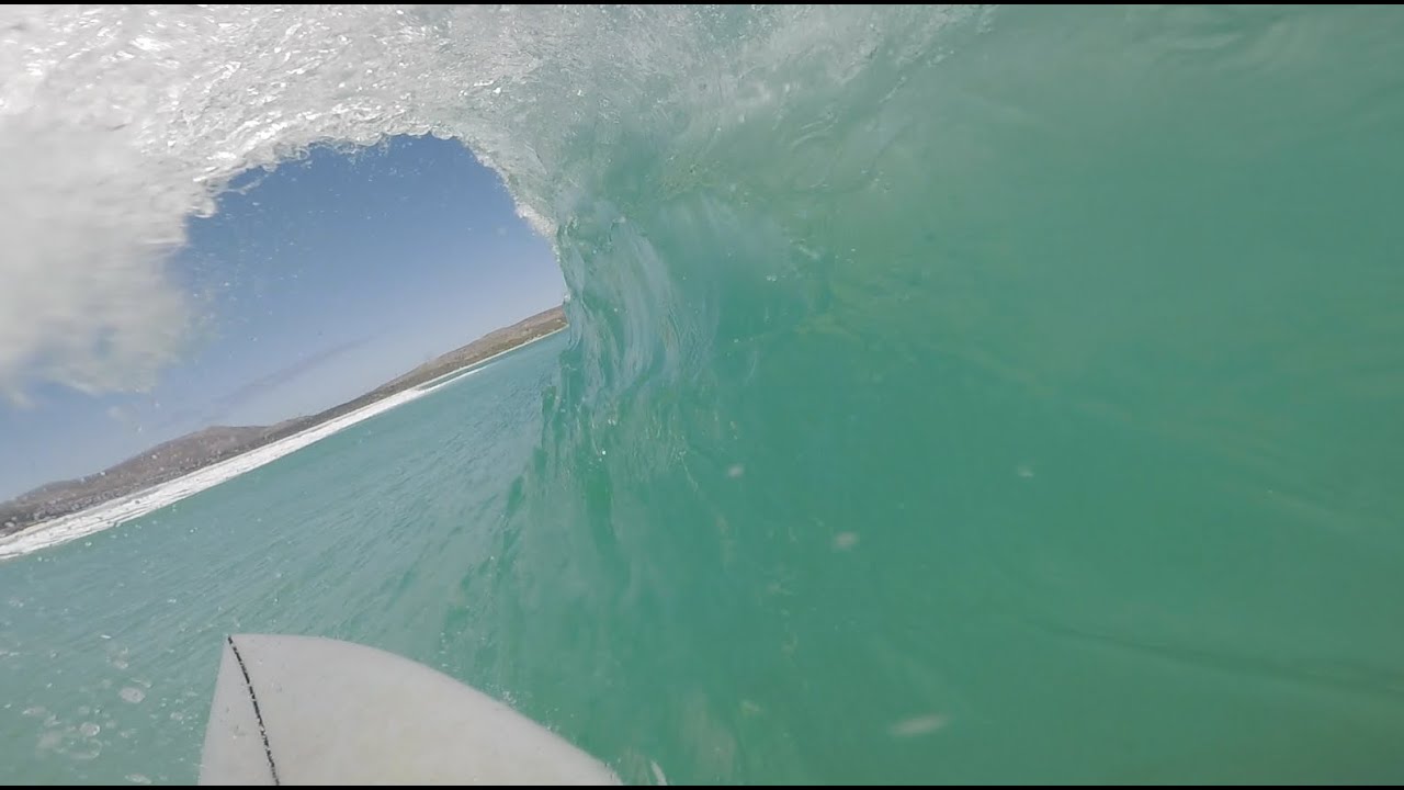 POV Surfing crystal clear water in Cape Town
