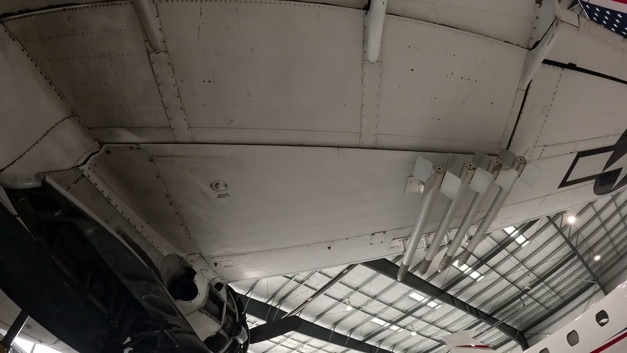 Under the wings and fuselage of the 'Island Doll', a Lockheed PV-2 Harpoon from WWII