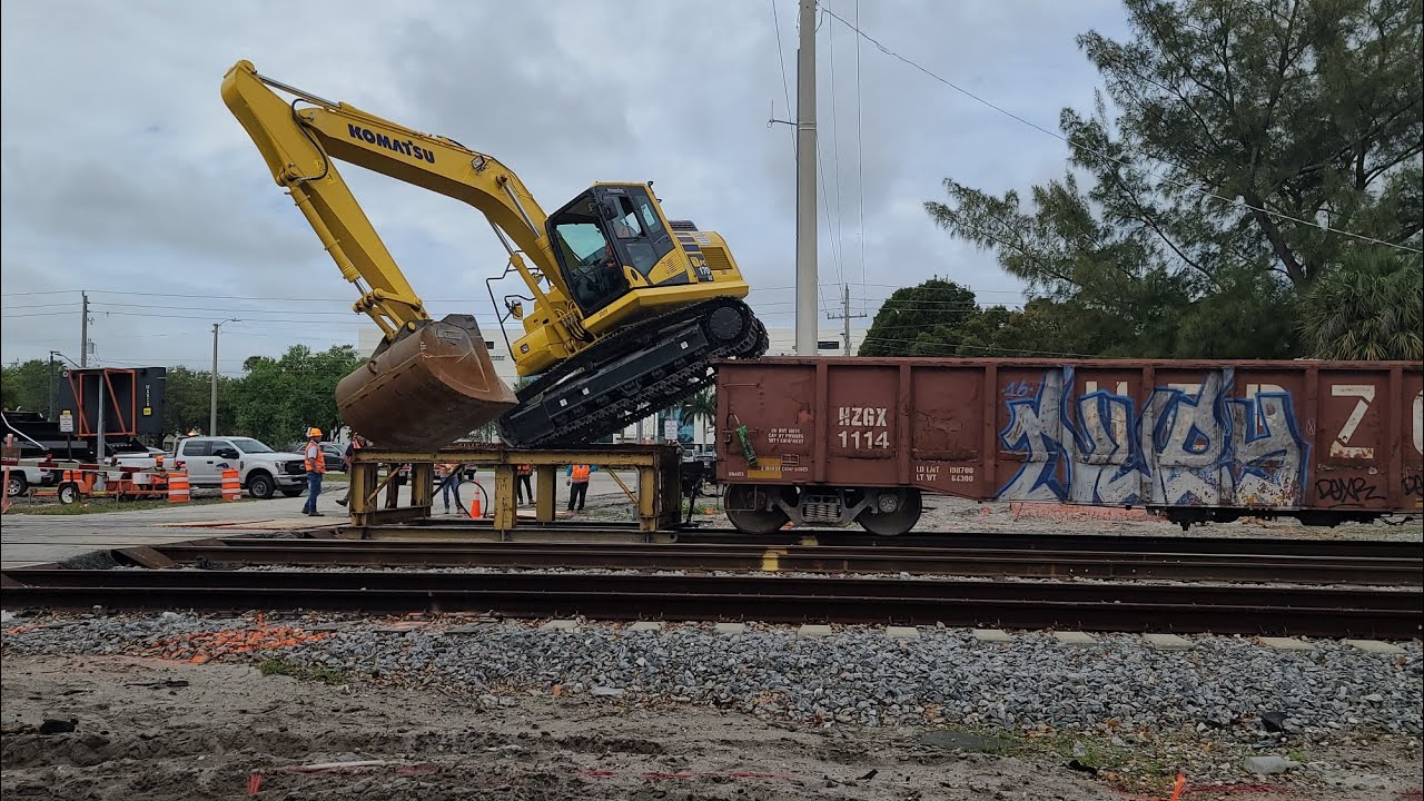How does an excavator board a train?