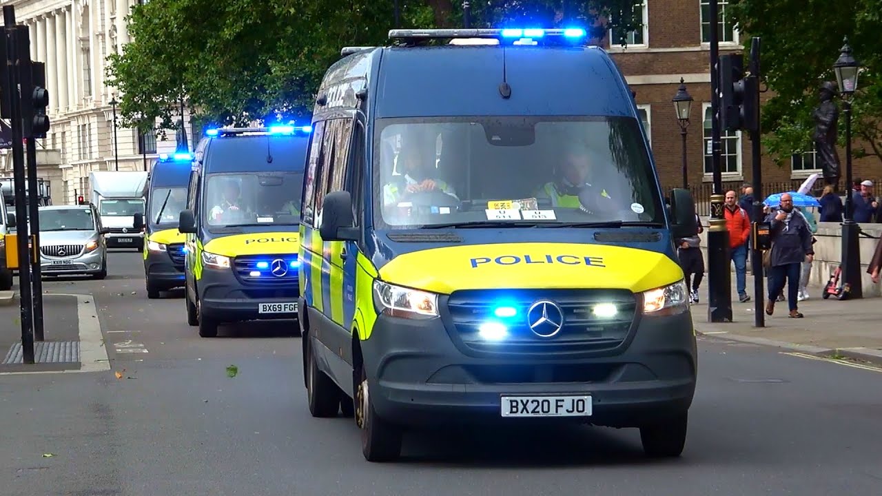 Multiple police vans emergency lights + sirens swarm Westminster in London