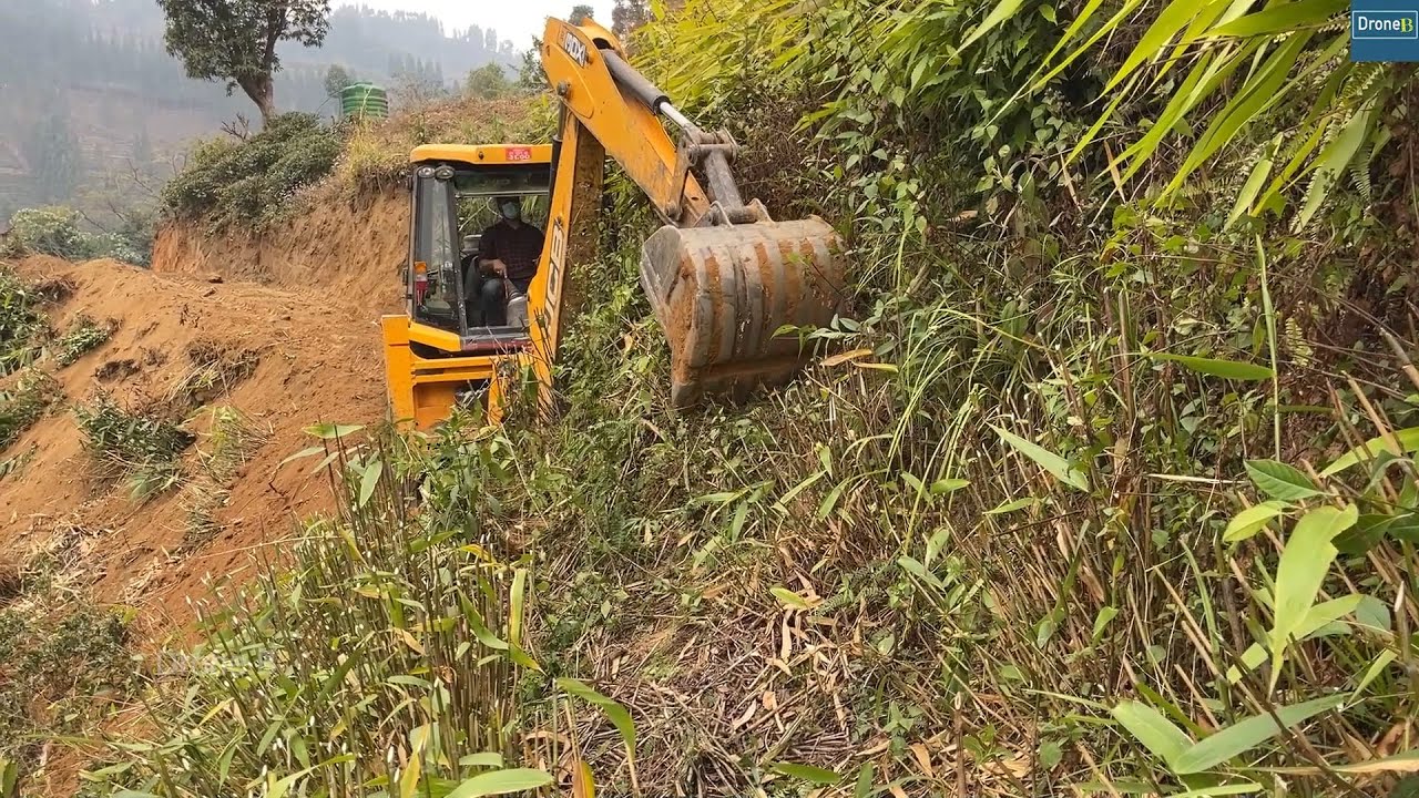 JCB Backhoe in Action Making Remote Mountain Narrow Road