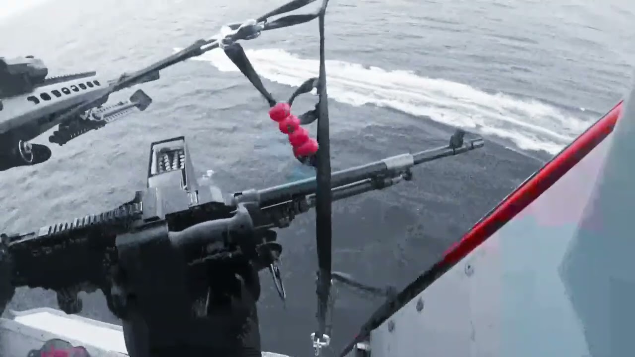 A Coast Guard HITRON MH-65E Dolphin aircrew during drug interdiction operation