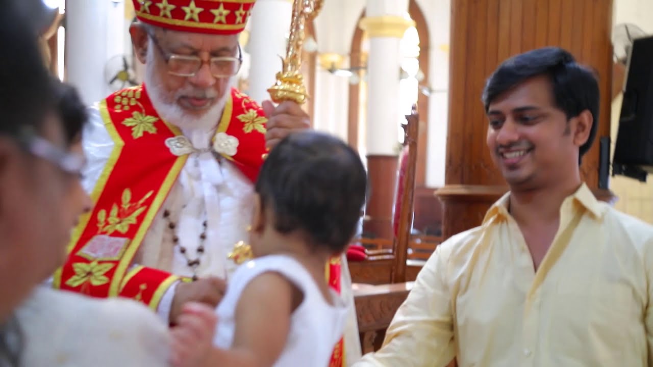 Cardinal Mar George Alencherry gives his hand cross to baby