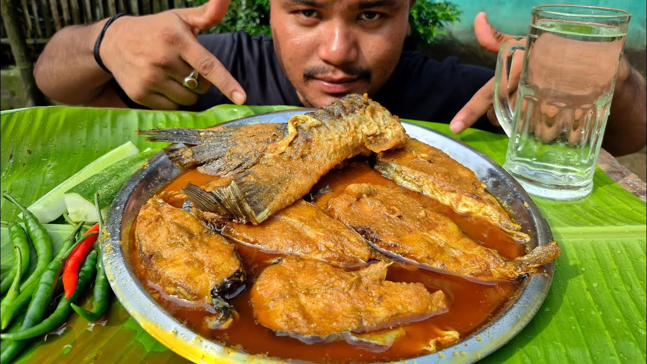 EATING SPICY FISH CURRY WITH GREEN CHILLI 
