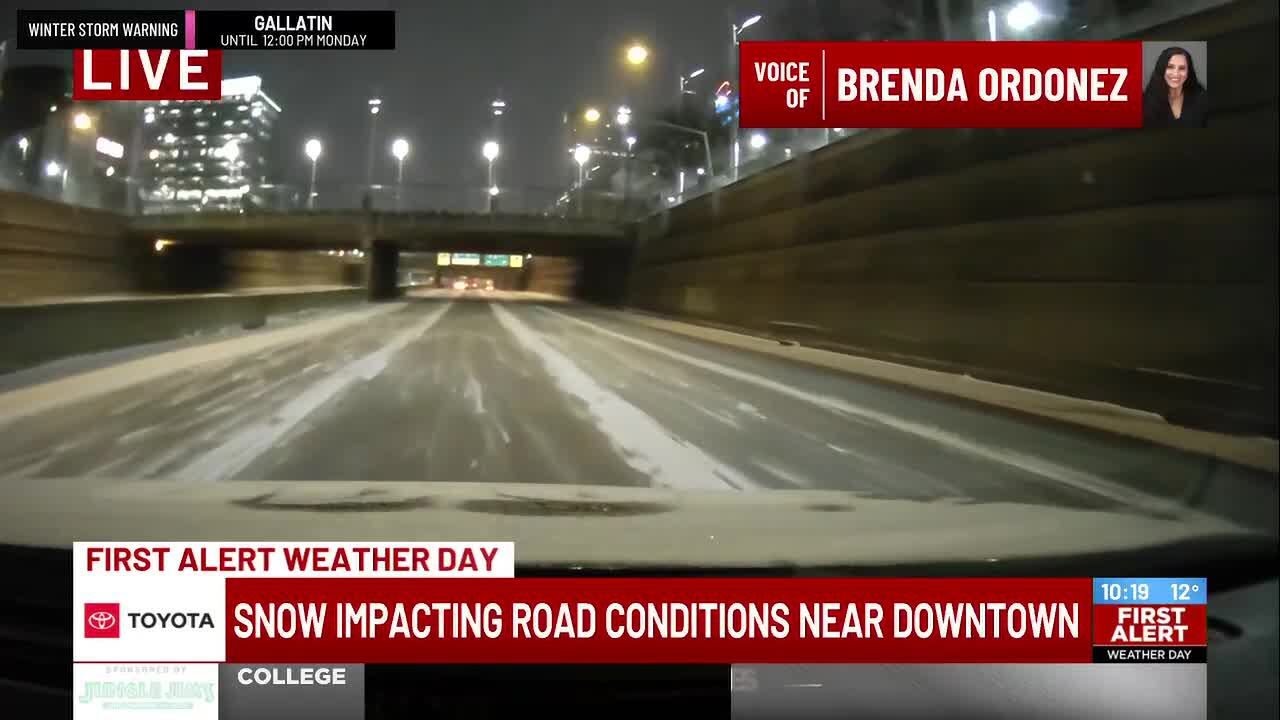 Snow impacting road conditions near downtown