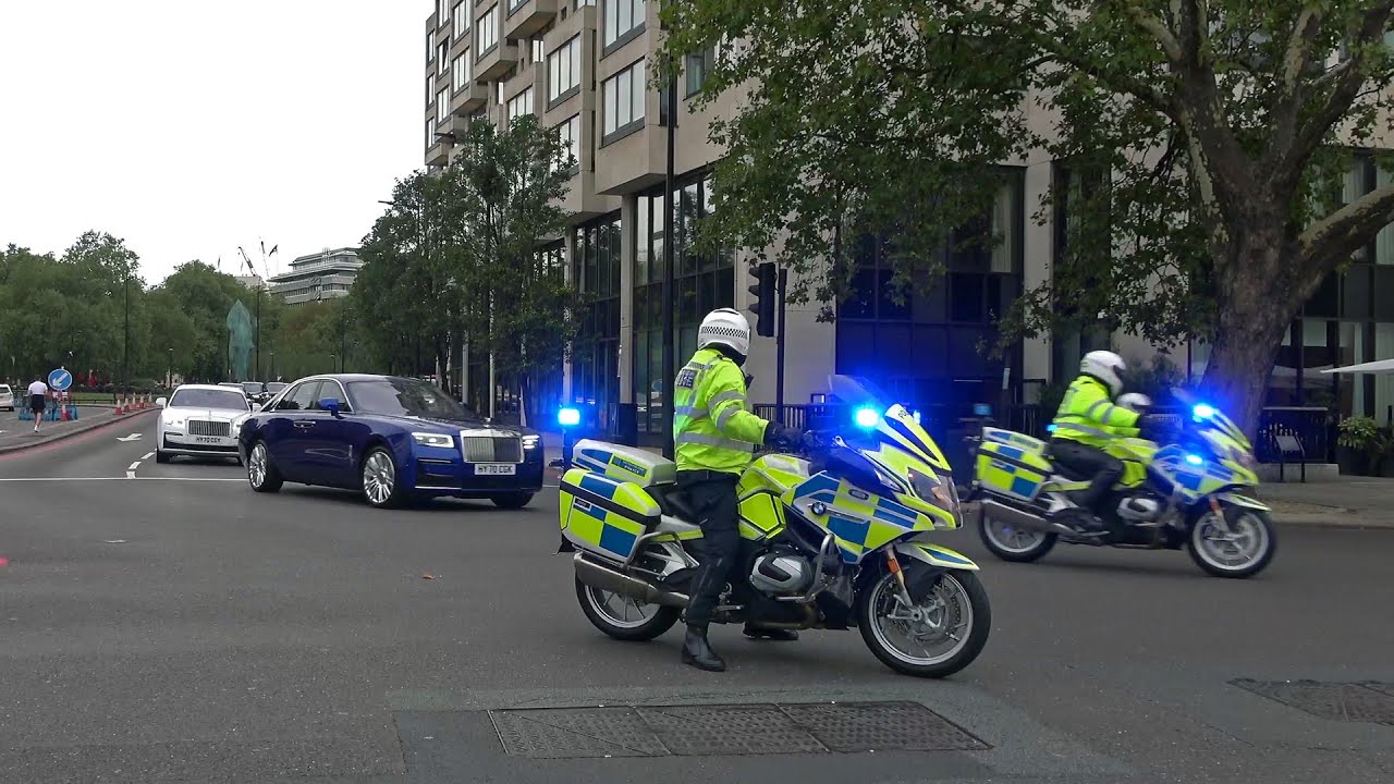 Convoy of luxury cars escorted by police