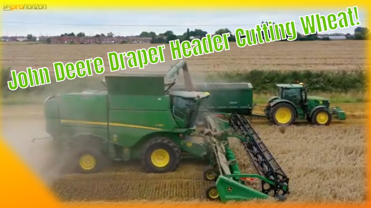 Nice looking John Deere Draper Header on this John Deere S785i Combine Cutting Wheat