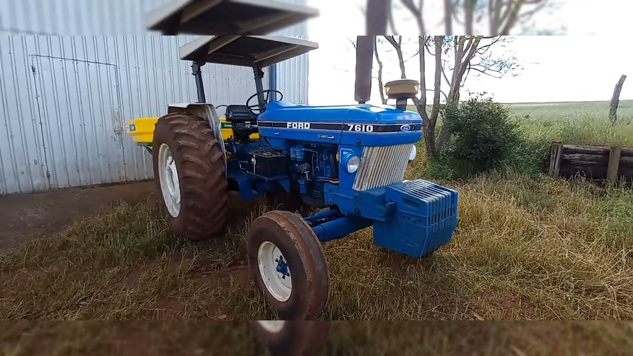trator Ford,  comando e braços hidráulico funcionando juntos.