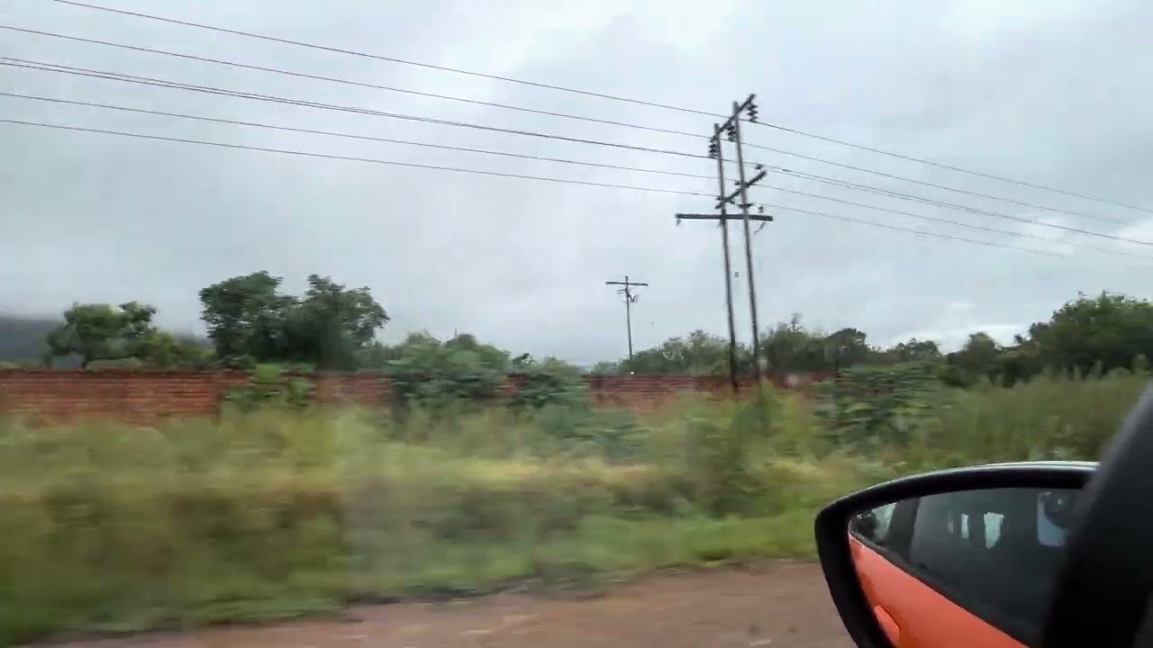 Driving East in Van der Hoff Road past ten rooms, South Africa.