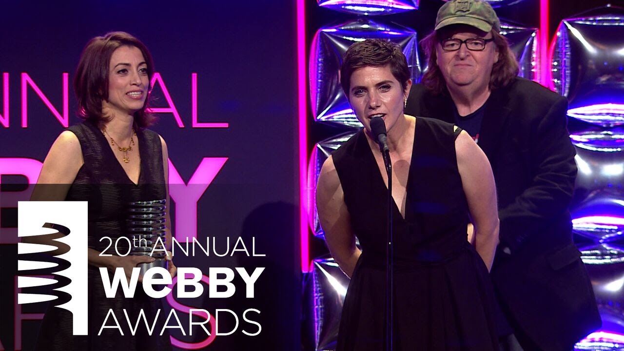 Michael Moore presents to Moira Demos & Laura Ricciardi at the 20th Annual Webby Awards