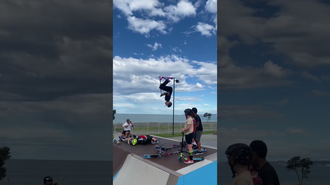 Pro Scooter Girl does backflip over scooter riders at the skate park!