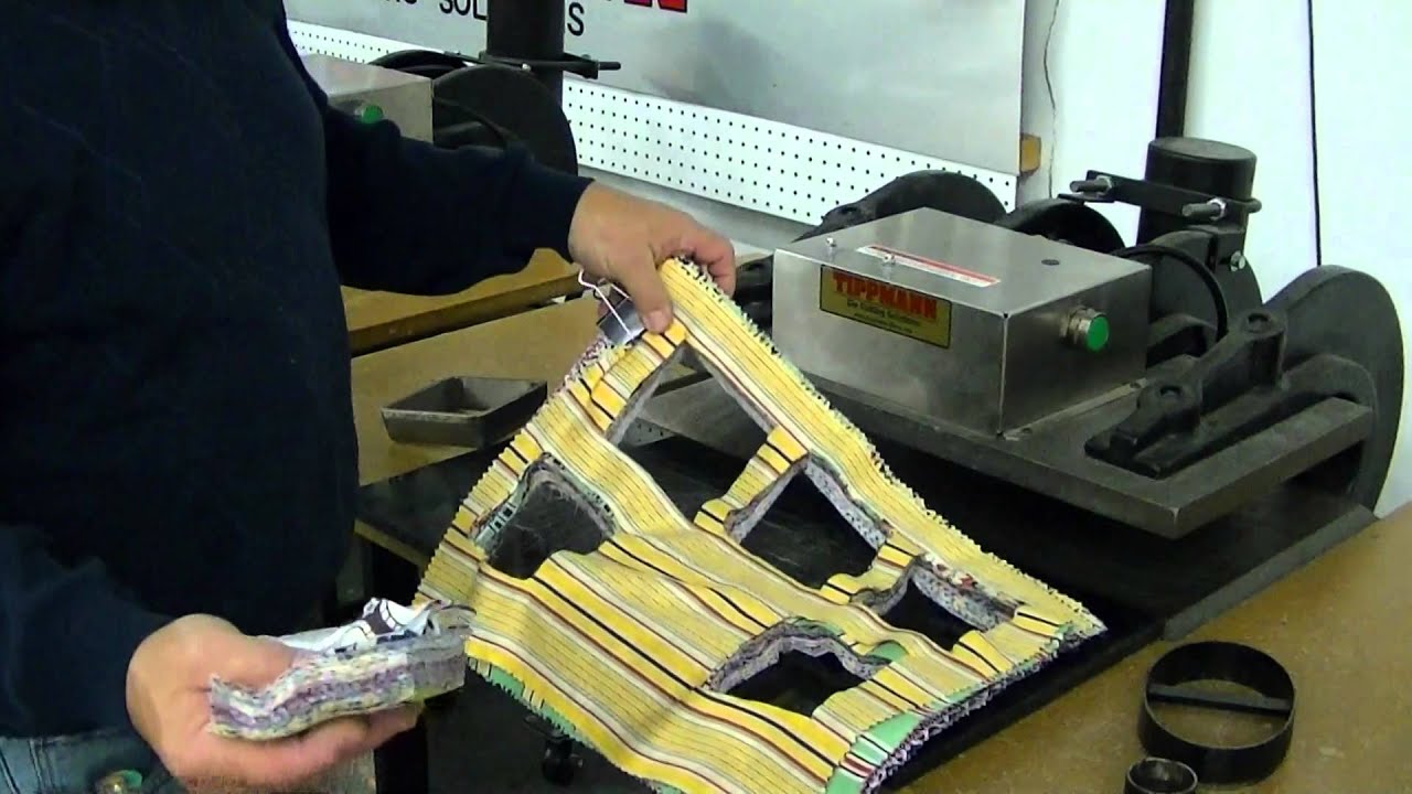 Clicker die cutting press die cutting thick stack of fabric.  Tippmann Clicker steel rule die cutter