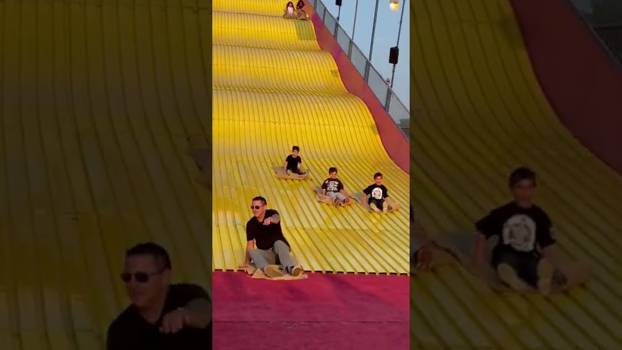 Colin goes on the yellow slide at the Big E￼