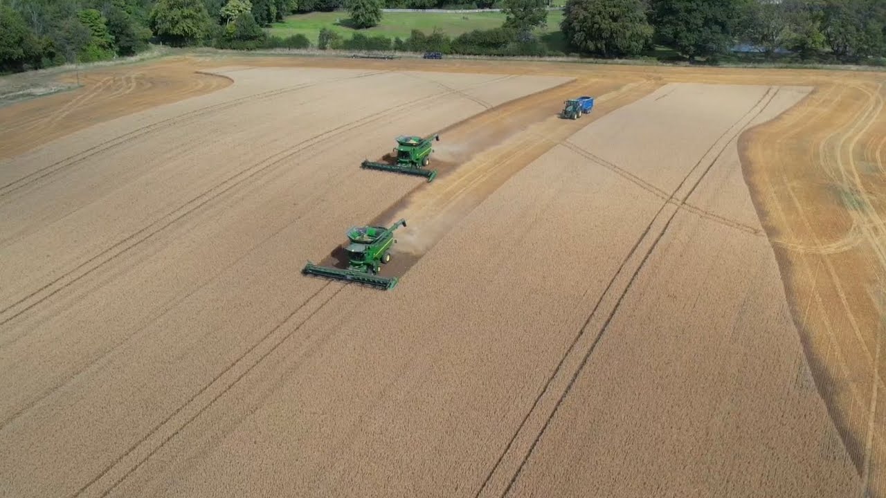 2 John Deere 785i’s with 735 D headers cutting oats in an awesome back drop!!!