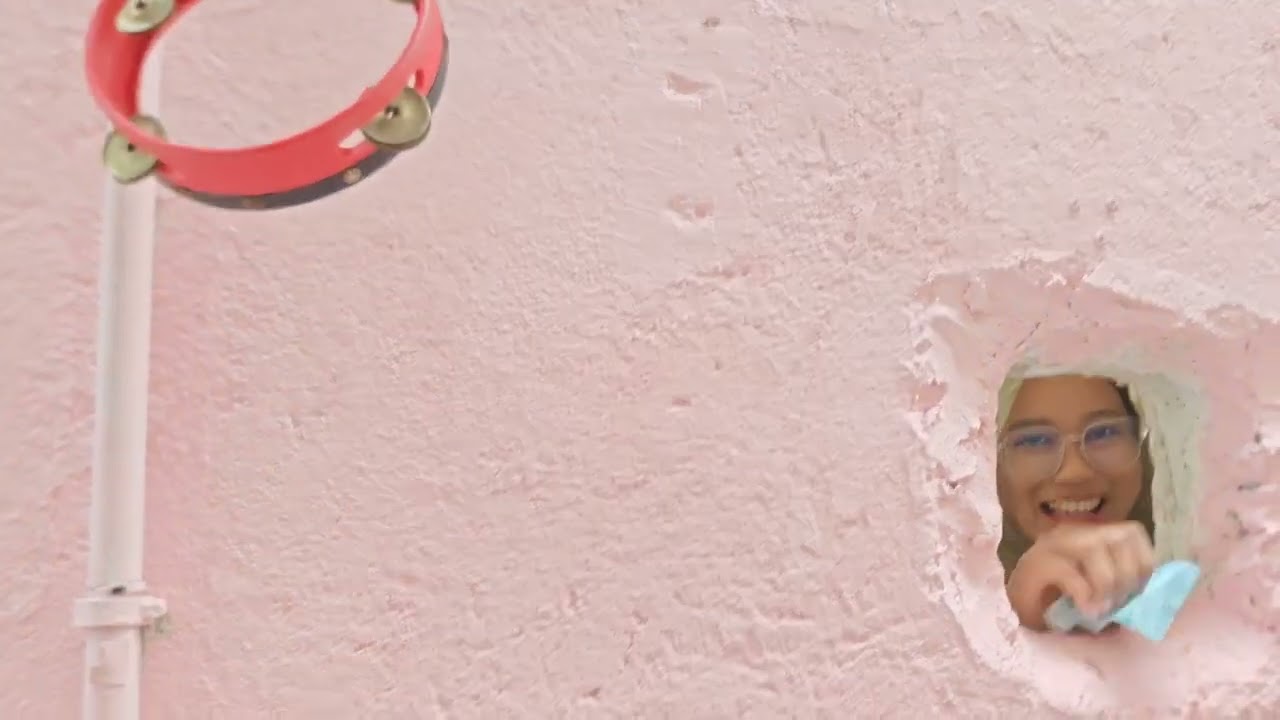 Jamboo KL cafe - playful monster hand serves drink through hole in the wall