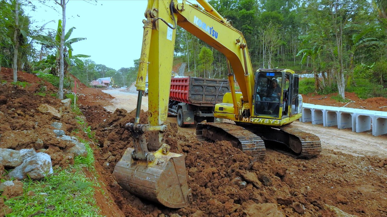 Road Excavation Construction Excavator Loading Dirt into Dump Trucks