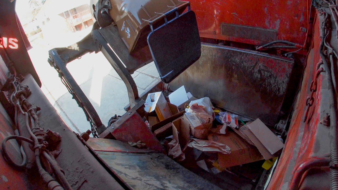 GoPro Hopper View of a McNeilus Side Loader Garbage Truck Packing Recycling