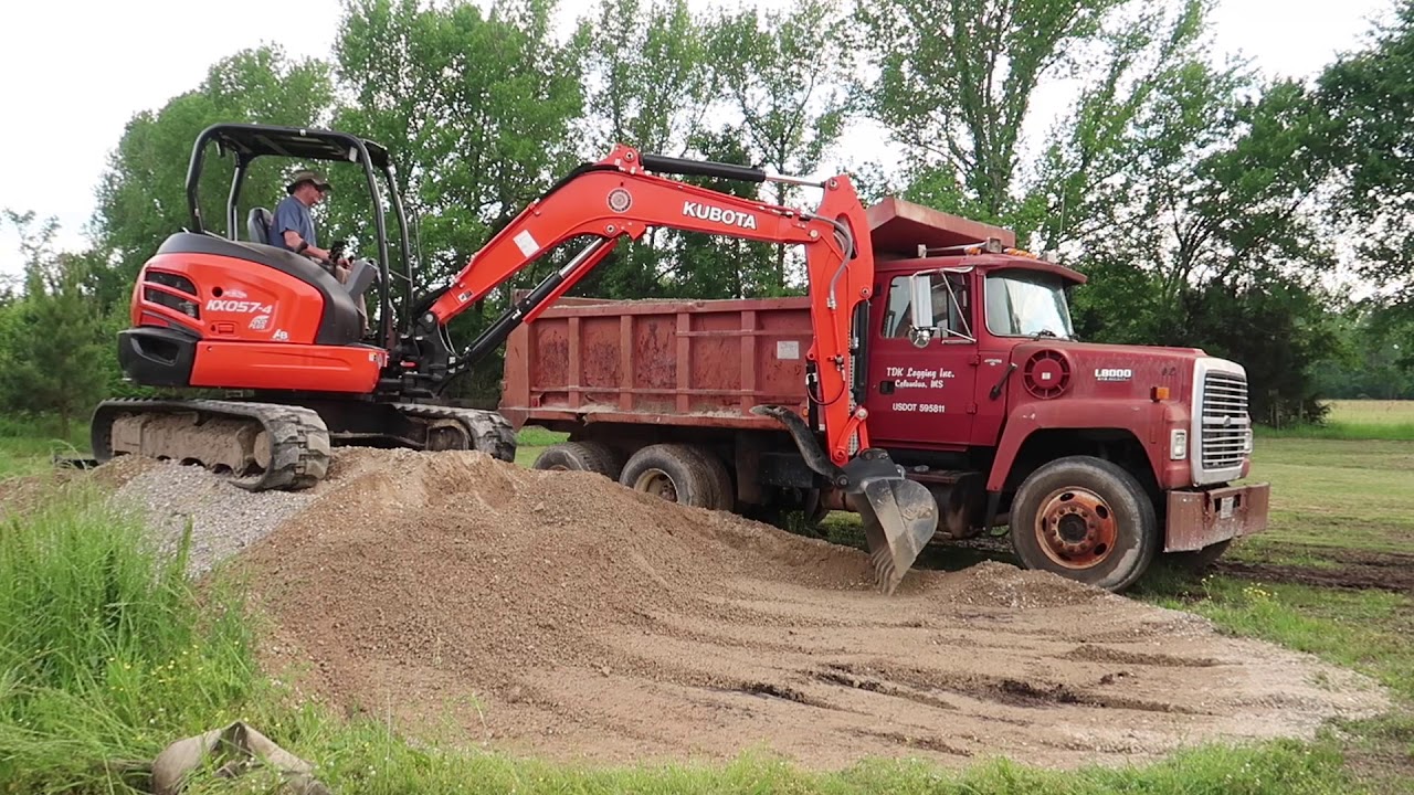 Kubota KX057-4 loading a Ford L8000 dumptruck
