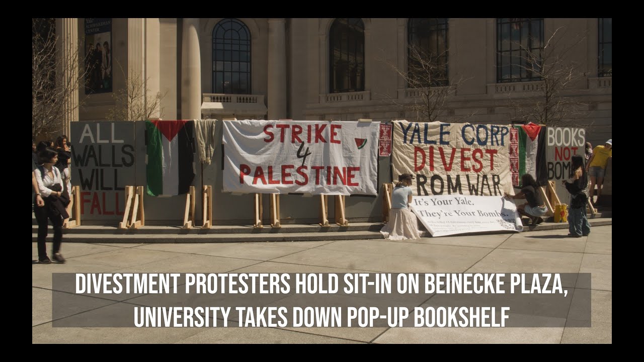 Divestment protesters hold sit-in on Beinecke Plaza, University takes down pop-up bookshelf