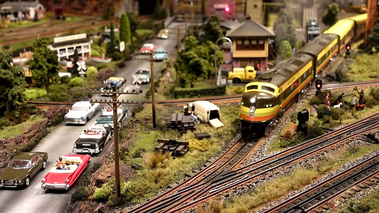 LIONEL AND MTH O GAUGE RUNNING ON SUPER DETAILED LAYOUT.