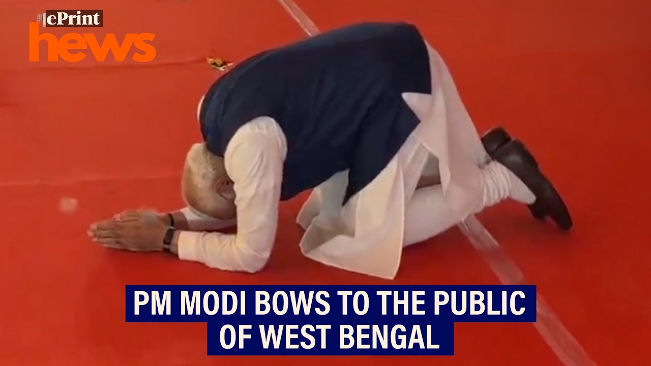 Prime Minister Narendra Modi greets people at the West Bengal swearing-in ceremony