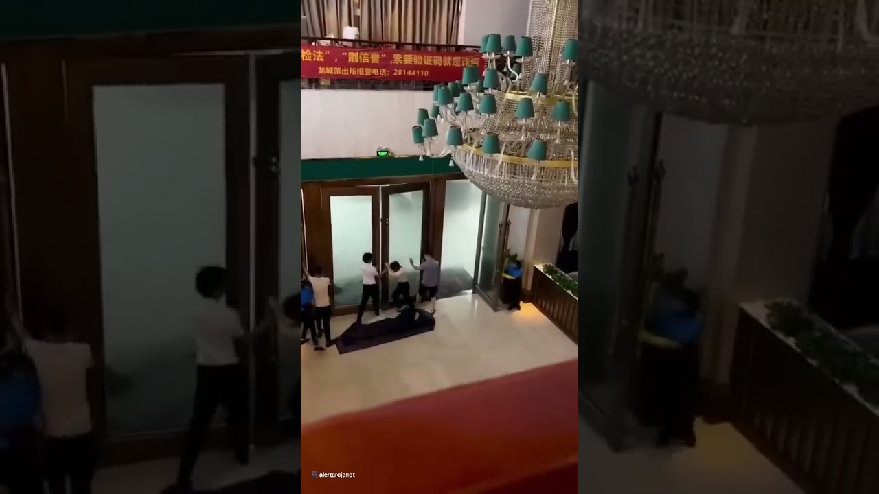 Staff cling onto doors as super Typhoon hits hotel
