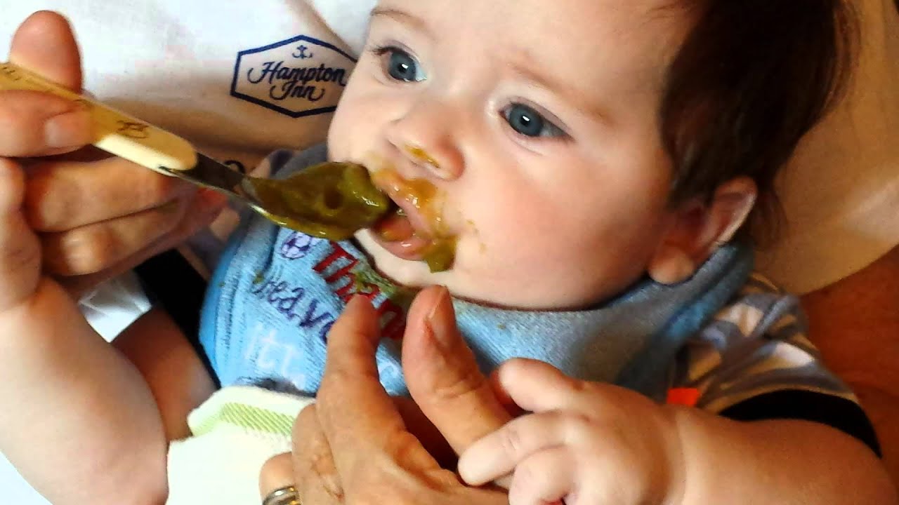 Grandmother spoon feeding for the first time
