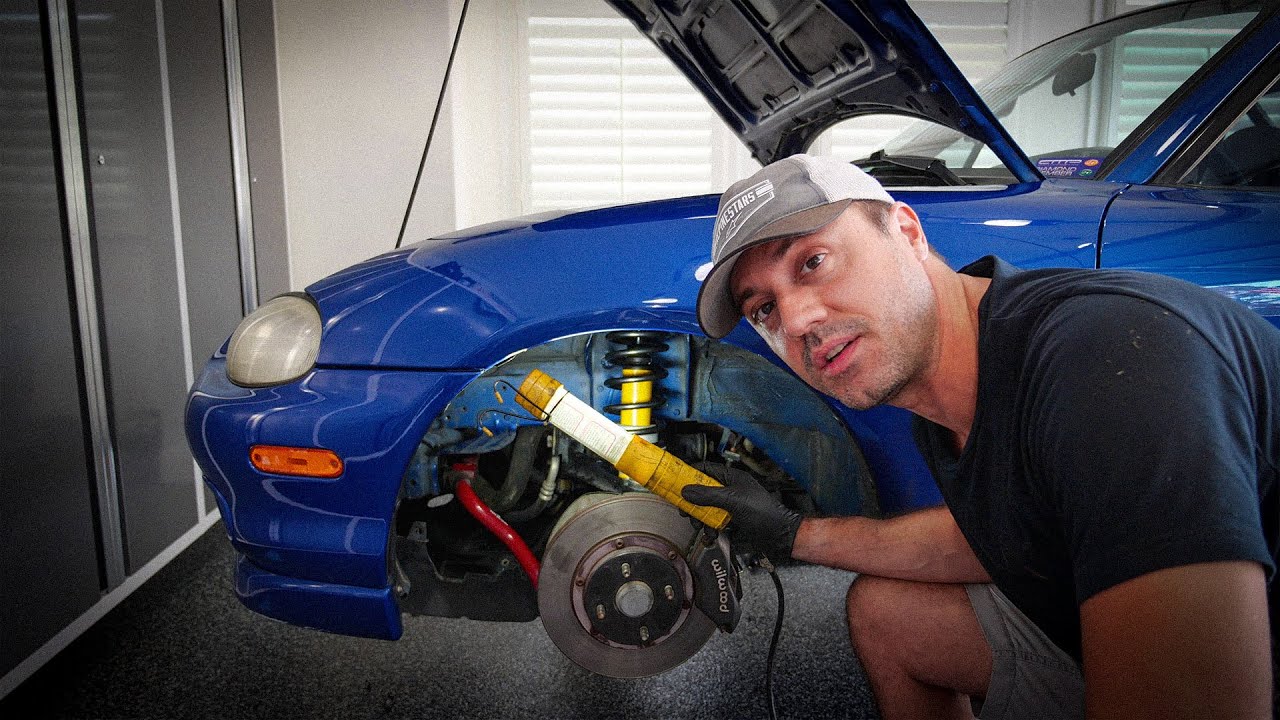 Installing fresh suspension components on a 1999 Miata.