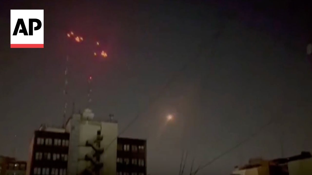 Iran air defenses fire into the sky as Israel strikes Tehran