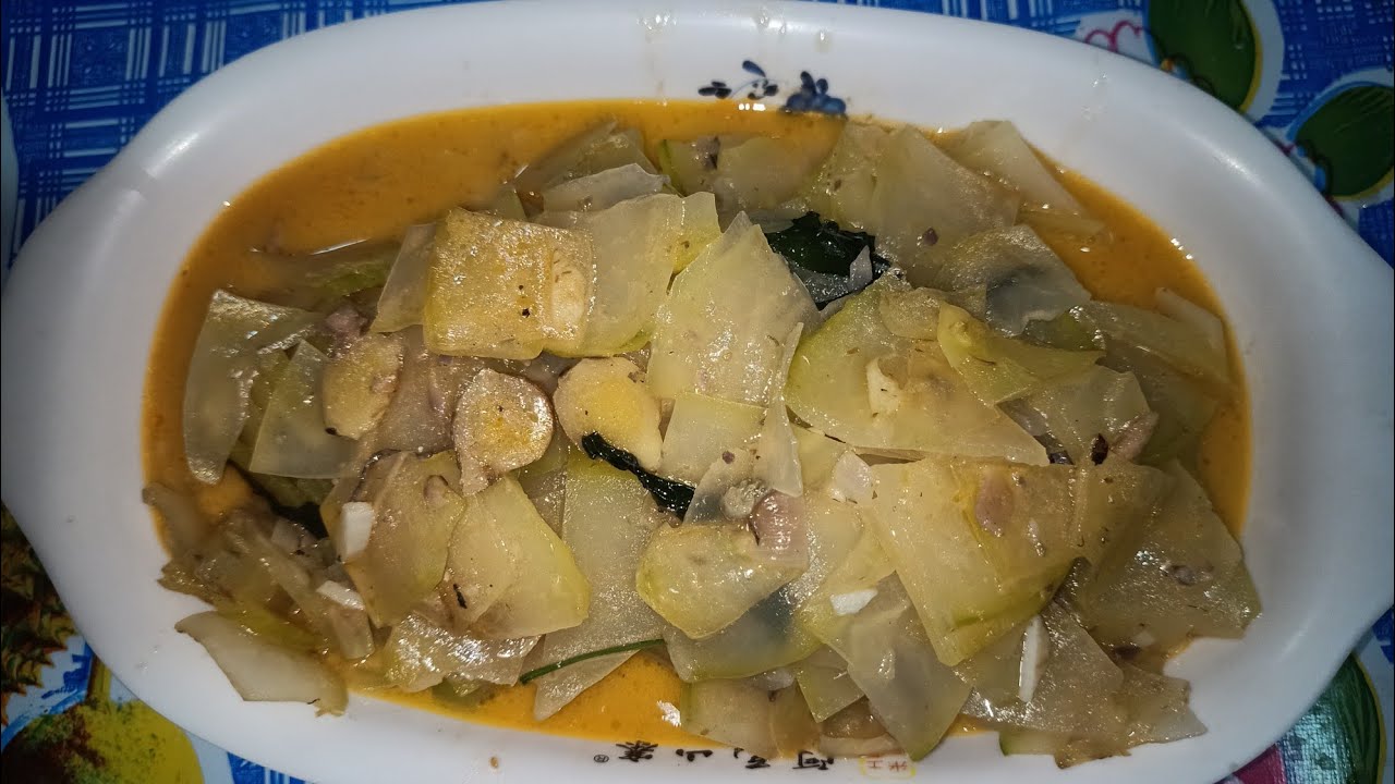 Cooking papayang ginataan with sardinas