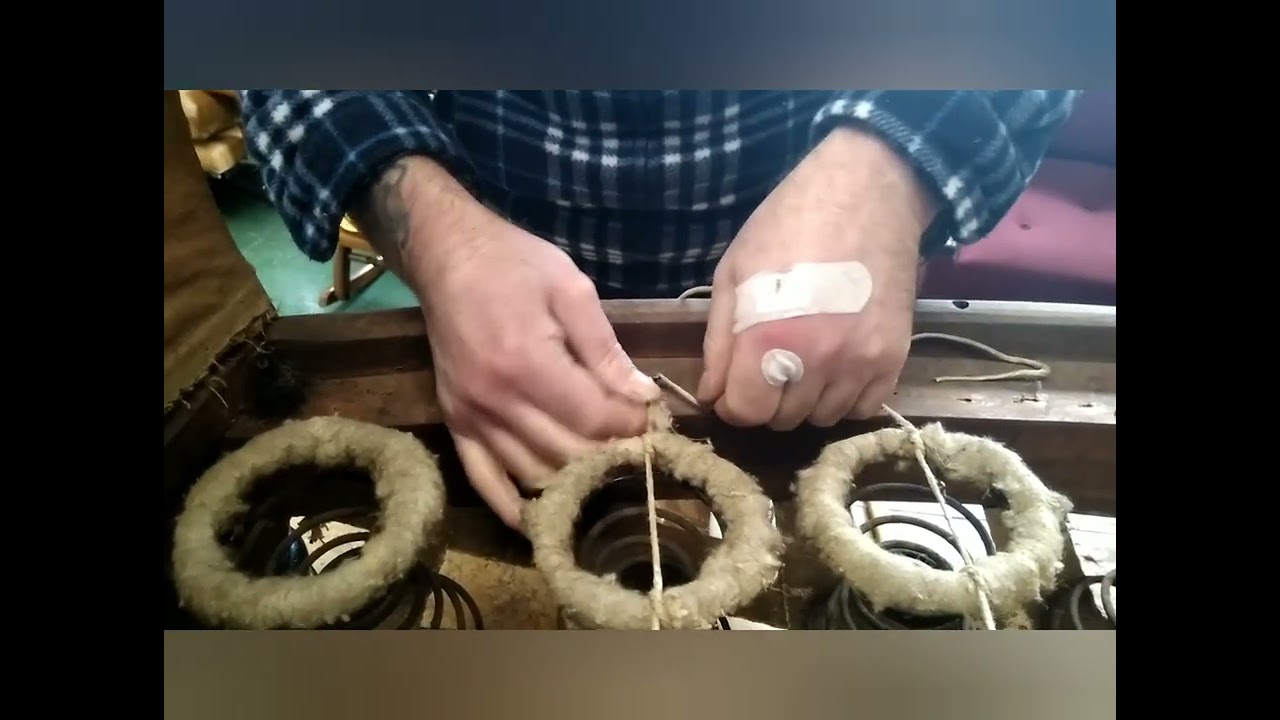 Lacing traditional coil springs on an upholstered chair seat