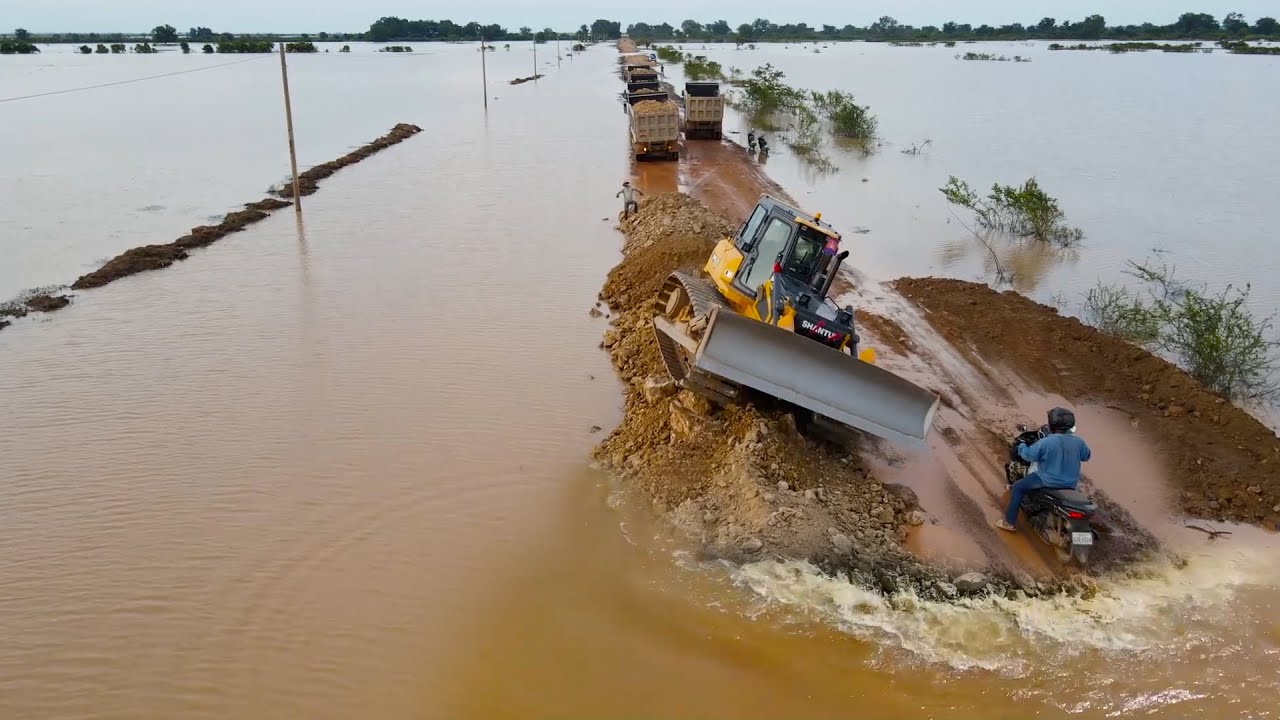Team Work Build Road Long Crossing Flood Using Bulldozer and Dump Truck Good Process in Operation