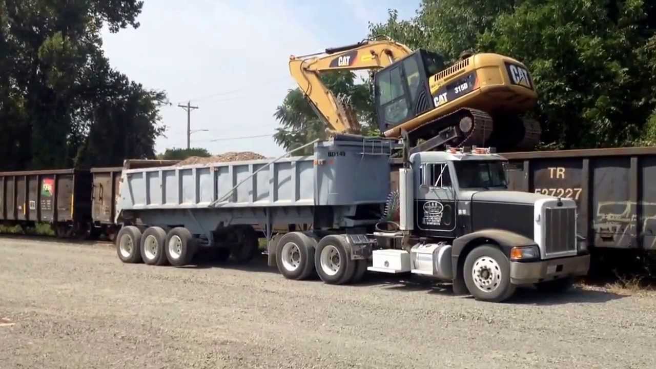 Track hoe on rail car unloading rock- Please subscribe to my channel